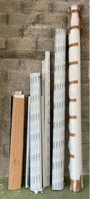 a stack of books sitting on a shelf next to a wall