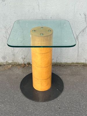 a glass table with a wooden base and a glass top