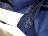 a close up of a blue jacket and a pair of shoes