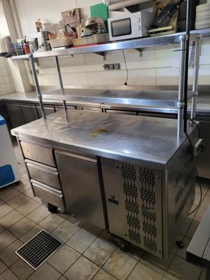 a kitchen with stainless steel counter tops and cabinets