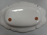 a white plate with two orange buttons on it