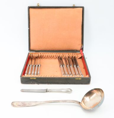 a silverware set in a case with a spoon and spoon rest
