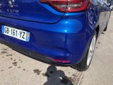 a blue car parked on the side of the road
