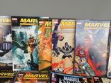 a lot of comic books that are on the table