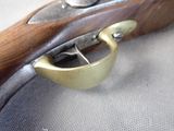 a close up of a rifle that is on a table
