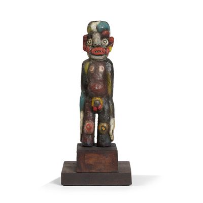 a close up of a statue of a person on a wooden base