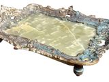 a silver tray with a mirror on top of it