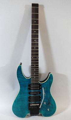an electric guitar sitting on top of a white surface