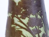 a glass vase with a tree design on it