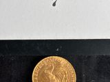 an image of a gold coin sitting on top of a black surface