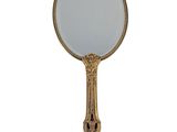 an antique brass mirror with a white glass in the middle