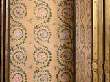 an image of a room with a wallpapered wall and a door