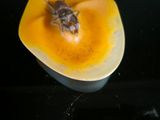 a bee that is sitting inside of a yellow squash