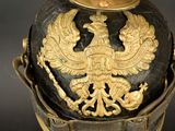 a black and gold helmet with a gold eagle on it