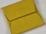 yellow leather business card case on a white surface