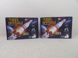 two boxes of plastic space toys are sitting on a table