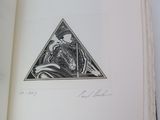 an open book with a drawing of a man in a triangle on it