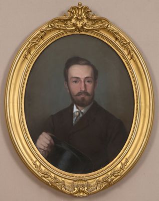 portrait of a man in a suit and tie holding a hat