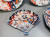 many plates with different designs on them on a table