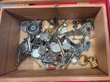 a wooden box filled with assorted items on a table