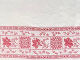 a white towel with a red floral design on it