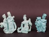 three chinese jade figurines of a woman, a man and a child