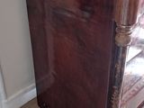 a wooden dresser with a mirror on top of it
