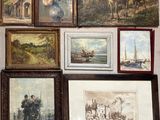 many framed pictures on the wall of this room