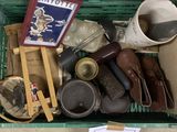 a green basket filled with assorted items on the floor
