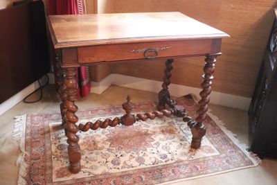 a small table with a wooden top on a rug in a room