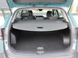 the back of a car with its trunk open and the back seats down