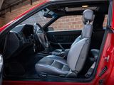 the interior of a red truck with the door open