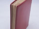 a red book that is open on a white surface