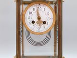 a gold clock that is sitting on a table