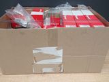 a cardboard box filled with red and white items