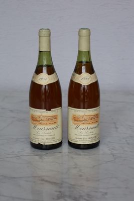 two bottles of wine that are sitting on a table