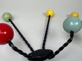 three balls that are attached to a hook on the wall