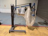 a crane with a bag on it in a warehouse