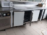 an image of a commercial kitchen with stainless steel counter tops and appliances