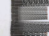 a close up of a bunch of drill bits laying on a table