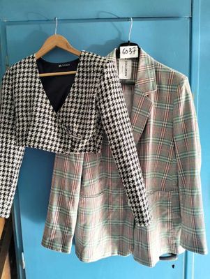 houndsered blazer jacket on a hanger in front of a blue door