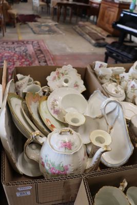a box full of teapots and saucers in a living room