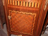 a wooden cabinet with a decorative design on it