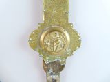 a gold clock that is on the wall