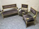 trois chaises et un canapé dans une pièce, avec un mur en arrière-plan