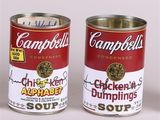 campbell ' s chicken and dumplings soup cans are displayed on a white surface