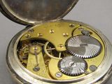 a close up of a pocket watch with a clock inside of it