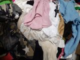 a pile of clothes sitting on top of a pile of clothes
