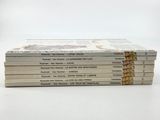 six books stacked on top of each other on a white surface