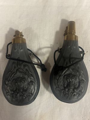 paire de flacons de parfum noir et or sur un tissu blanc